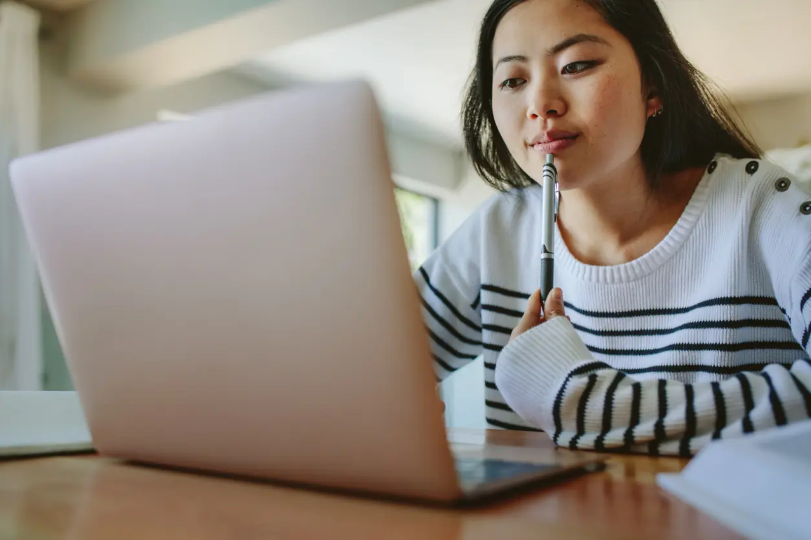 a woman researching on her laptop