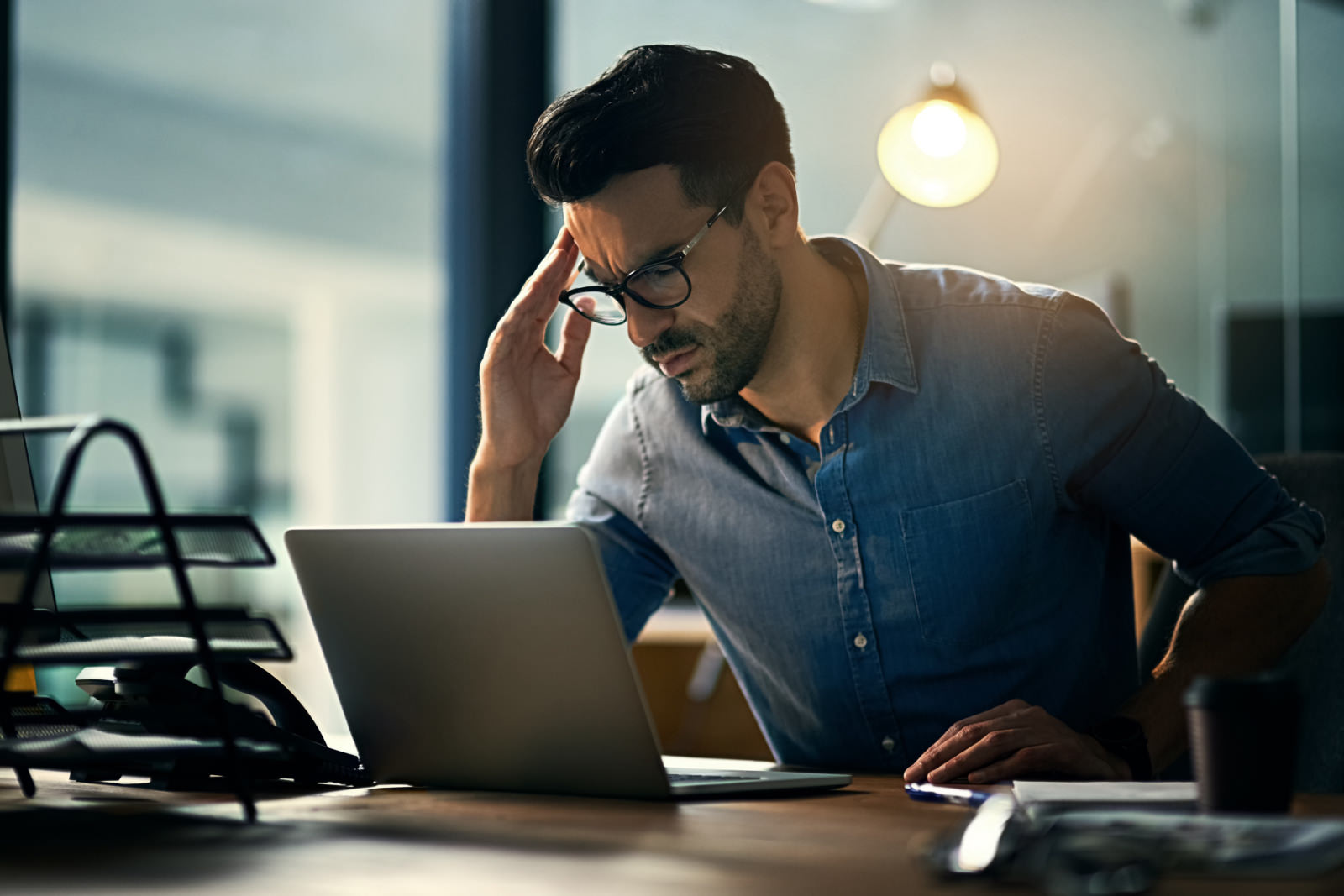 a man looking at his laptop stressfully